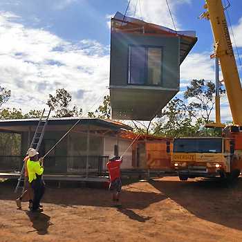 Crane lifts home modules into place