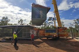 Lifting the elevated house modules into place