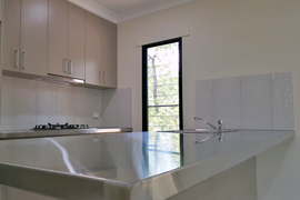 Kitchen with stainless steel bench tops