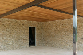 Ground level home with textured finished in outdoor living area